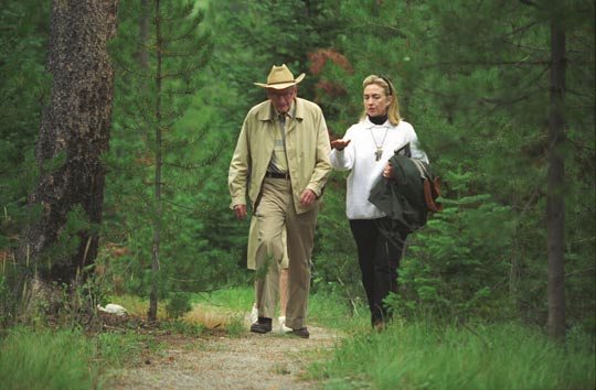 Hillary Clinton and Laurance Rockefeller walking at his Wyoming Ranch (image credit: Clinton Library)