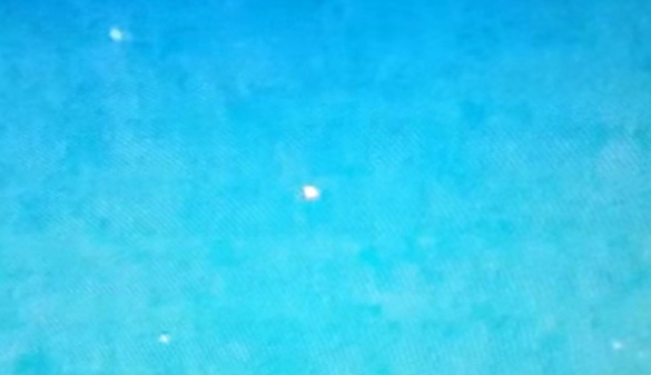 Still frame from the video showing several of the white orb UFOs. (Credit: YouTube/Daniel Neamtu/M.Cazares)
