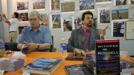 Don Schmitt and Tom Carey signing books and talking to visitors in the Roswell UFO Museum. (image credit: Alejandro Rojas)