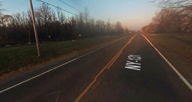 The witness first observed a solid looking reddish-orange sphere flying above and along power lines. Pictured: Route 131 in Massena, NY. (Credit: Google)