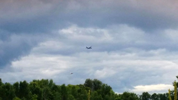One of the witnesses snapped this still image which shows the military plane and a disc-shaped object. (Credit: MUFON)
