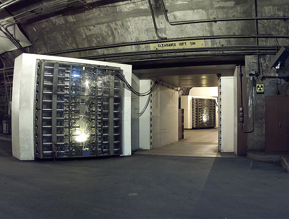 The 25-ton North blast door in the Cheyenne Mountain nuclear bunker is the main entrance to another blast door (background) beyond which the side tunnel branches into access tunnels to the main chambers. (Credit: Wikimedia Commons)