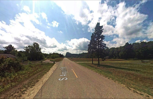 The Michigan witness near Newberry stopped his dirt bike along South Airport Road, pictured, to look at a silent object hovering over a nearby potato field. (Credit: Google)