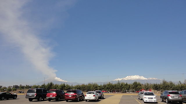 Popocatépetl seen from a parking lot at Hermanos Serdán International Airport. (Credit: Danielllerandi/Wikimedia Commons)