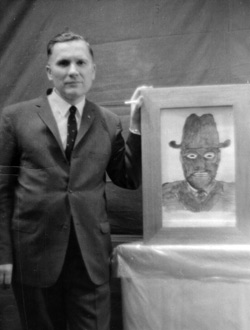 Albert Bender with a drawing of one of the Men in Black he encountered.