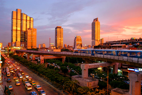A spectacular sunset in Bangkok, showing the skytrain and modern skyline down Thanon Naradhiwas Rajanagarindra, taken from the corner of Thanon Silom, with the Empire Tower and the Chong Nonsi BTS Station at the left side. (Credit: Wikimedia Commons/Diliff)