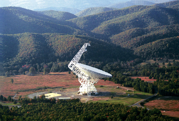 The Robert C. Byrd Green Bank Radio Telescope (GBT) focuses 2.3 acres of radio light. It is 485ft tall, nearly as tall as the nearby mountains and much taller than pine trees in the national forest. The telescope is in a valley of the Allegheny mountains to shield the observations from radio interference. (Credit: National Radio Astronomy Observatory)