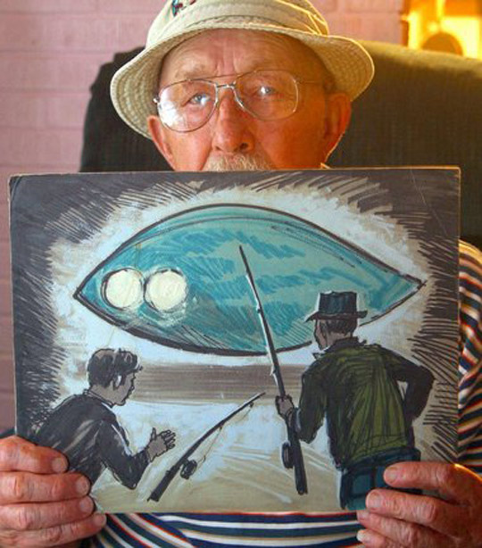 Charlie Hickson showing a painting of the 1973 Pascagoula abduction
