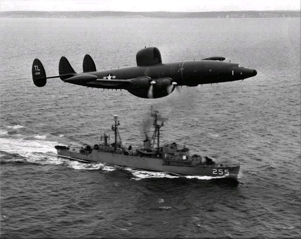 An Atlantic barrier U.S. Navy Lockheed WV-2 Warning Star overflies USS Sellstrom off Newfoundland in 1957. (Credit: Mahlon K. Miller/U.S. Navy)