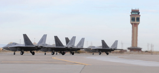 F-22 Raptors lined up on the airfield at Holloman AFB (image credit: USAF)