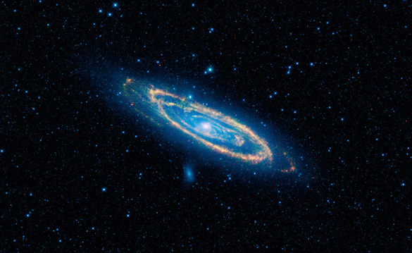 A false-color image of the mid-infrared emission from the Great Galaxy in Andromeda, as seen by Nasa's WISE space telescope.  The orange color represents emission from the heat of stars forming in the galaxy's spiral arms. The G-HAT team used images such as these to search 100,000 nearby galaxies for unusually large amounts of this mid-infrared emission that might arise from alien civilizations. (Credit: NASA/JPL-Caltech/WISE Team)