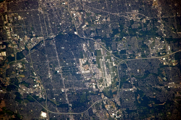 The witness saw a pale green triangle UFO crossing the sky. Pictured: Columbus International Airport seen from the International Space Station. (Credit: Wikimedia Commons)