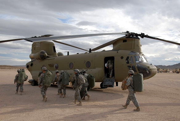 The helicopter appeared to be escorting the UFO. Pictured: Soldiers prepare to board a CH-47F at the National Training Center, Fort Irwin, California. (Credit: Wikimedia Commons)