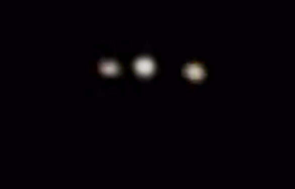 The lights appear to be attached to a triangle-shaped object. Pictured: Cropped and enlarged still frame from the witness video. (Credit: MUFON)