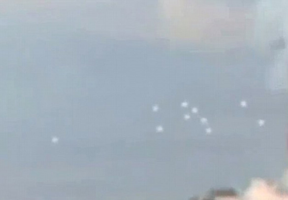 The 10 white, circular balls seems to move in a cluster. Some are comparing this video to a June sighting over Hyde Park, London. (Credit: The Daily Mail)