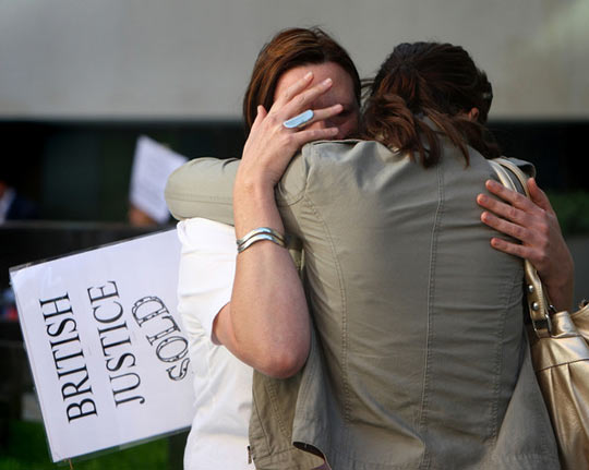 Lucy Clarke, McKinnon's girlfriend, is comforted at a protest. (credit: Cate Gillon/Getty Images Europe)