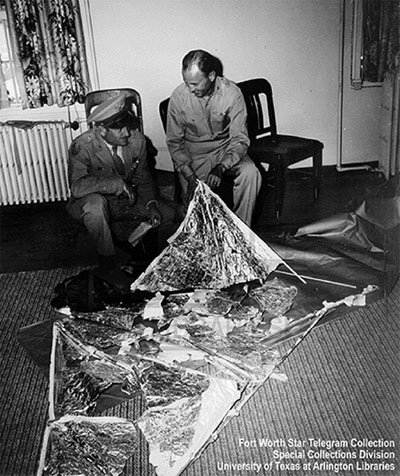 General Roger Ramey (left) with Colonel Thomas Dubois looking the weather balloon Ramey claimed was mistaken for a flying saucer in Roswell in 1947.